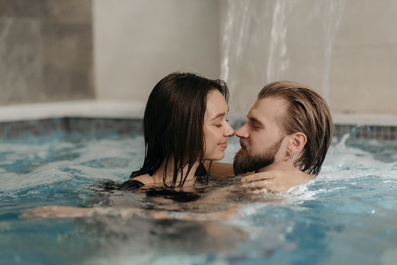 A couple kissing in a swimming pool