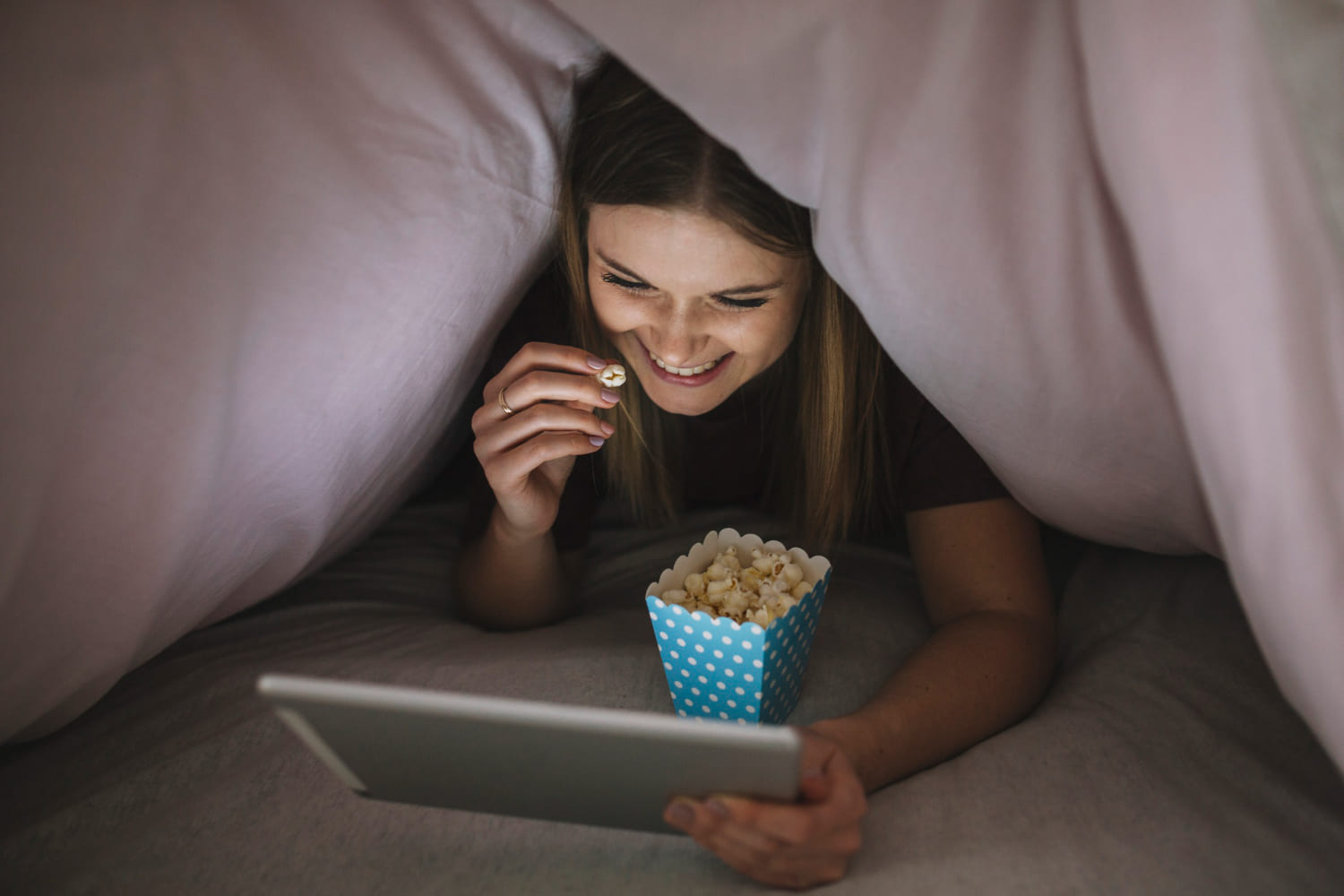 Fun and romantic virtual date ideas Couple on a virtual date woman smiling at her partner through video call